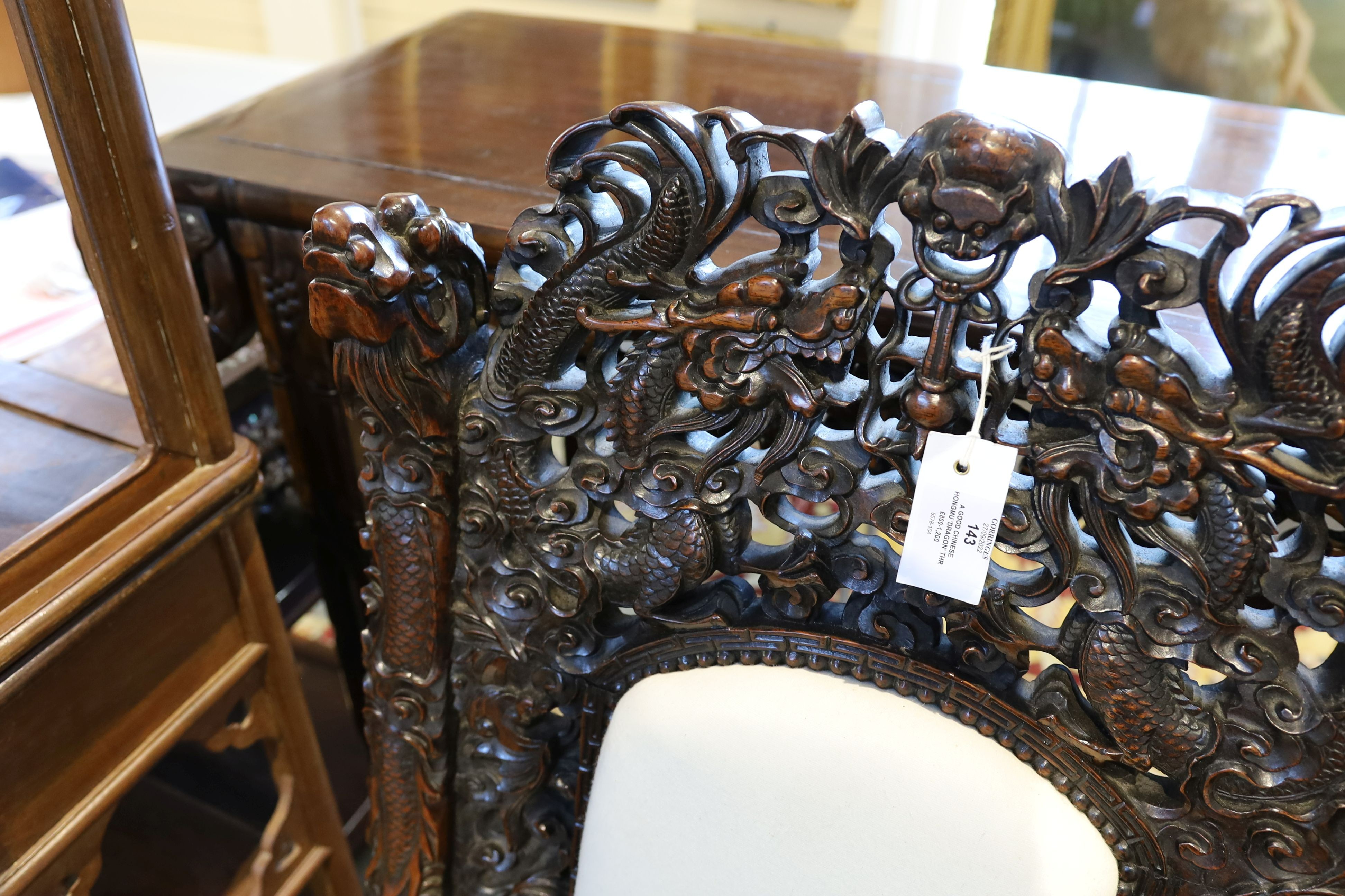 A good Chinese hardwood ‘dragon’ throne armchair, c.1900, 114.5cm high, 68cm wide at the arms